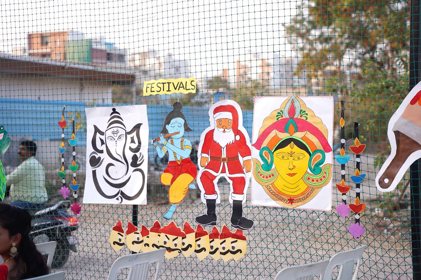 A handmade festivals-themed display corner at Little Ville Annual Day, featuring art for Ganesh Chaturthi, Christmas and Dussehra