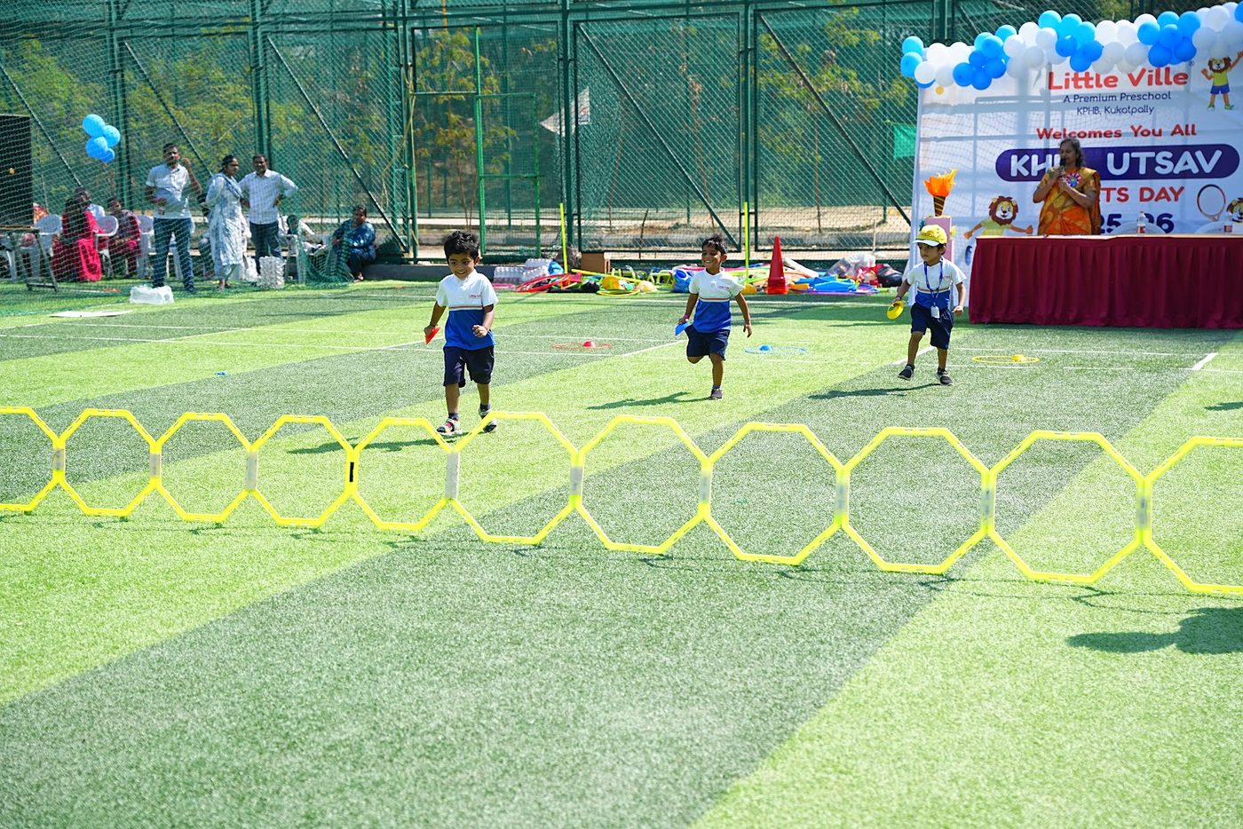 Students running an agility ladder drill on the field at Khel Utsav