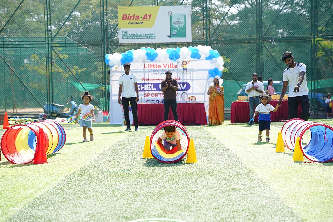 Children navigating tunnels and rings on the Khel Utsav obstacle course