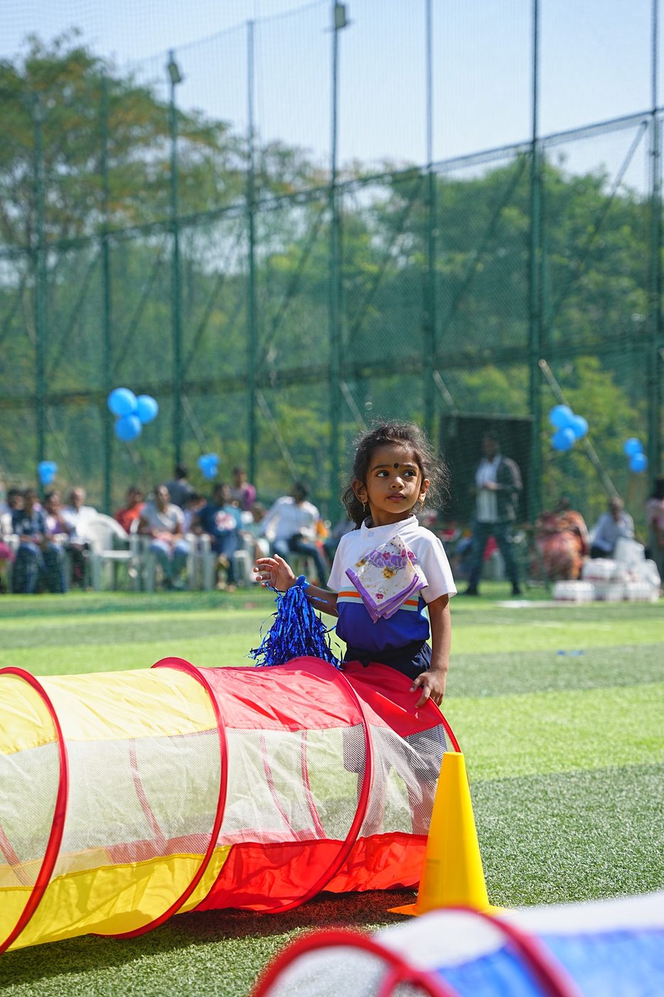 A Little Ville student emerging from a play tunnel at Khel Utsav Sports Day